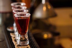 Barman make alcoholic shots in nightclub