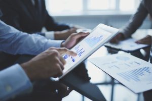 photo of people analyzing electronic document