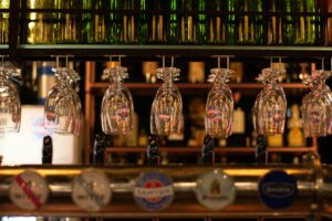Beer glasses hanging upside down at a bar